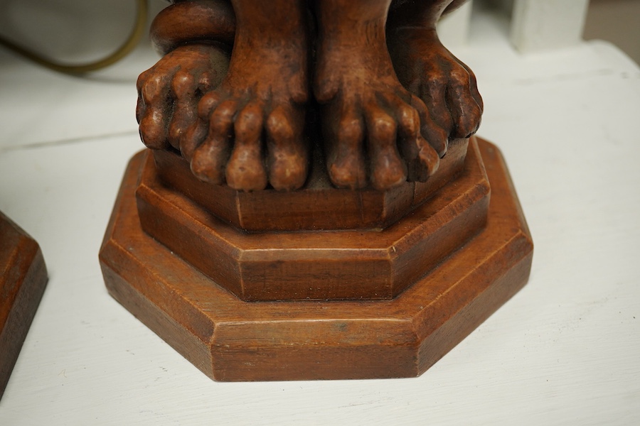 A pair of Thomas Blakemore faux oak 'lion' lamp bases, 47cm high overall. Condition - some minor chips